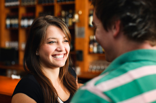 Attractive Brunette Woman Talking at a Bar w a Guy