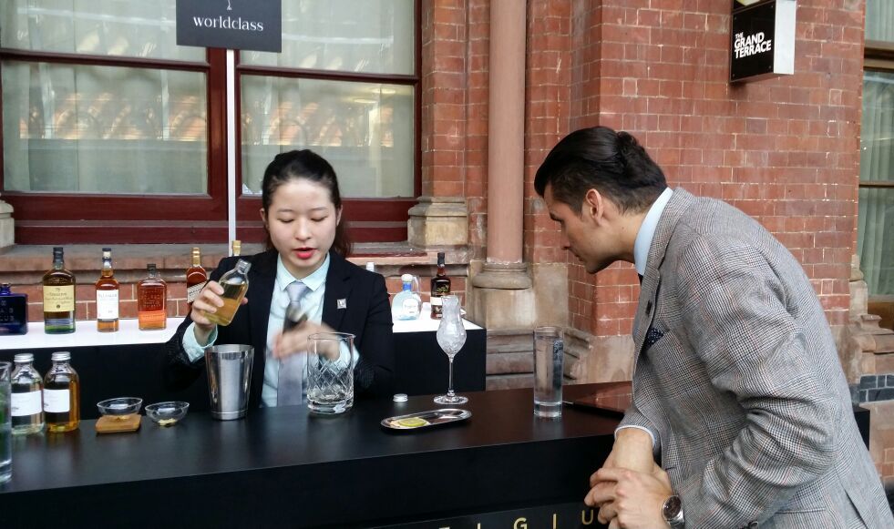 Yinying focused on the blending craft as a guest looked on intently