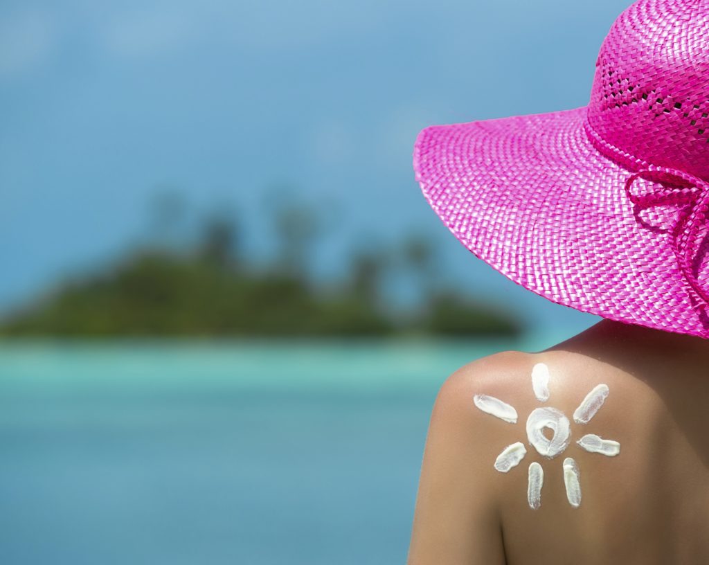 Woman with sun-shaped sun cream