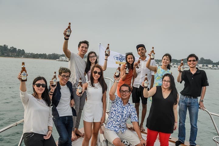 Tiger Beer marketing manager Jessie Chuah (third from left, first row) with guests during the Tiger White Expect the Unexpected experience on a yacht in Port Dickson.